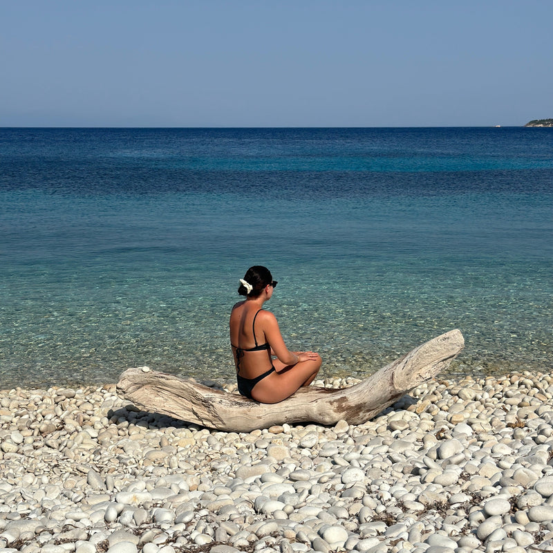 A woman sitting on the beach 